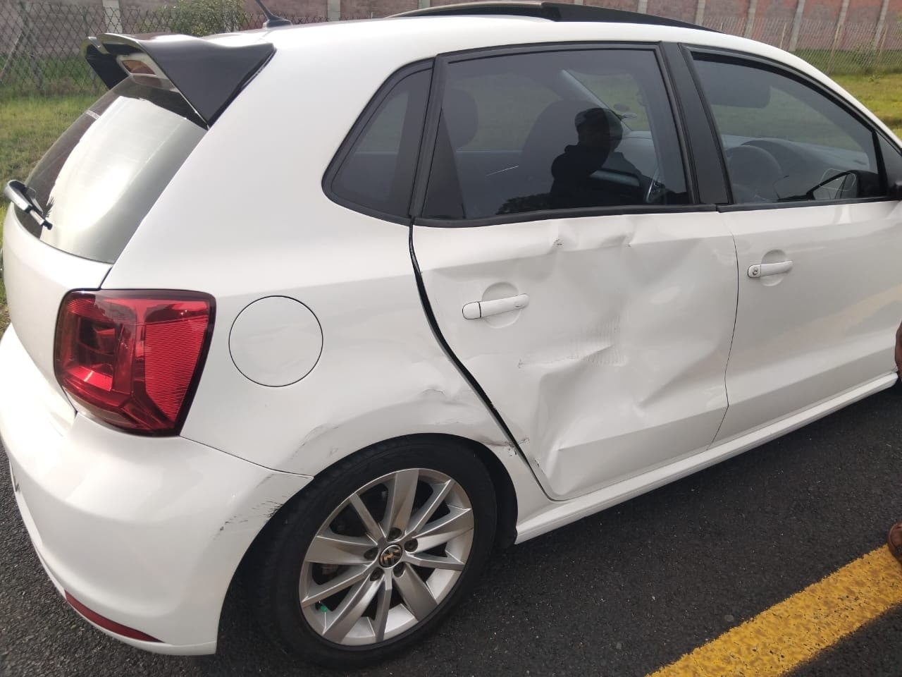 White Volkswagen Polo rear-side collision damage before repair