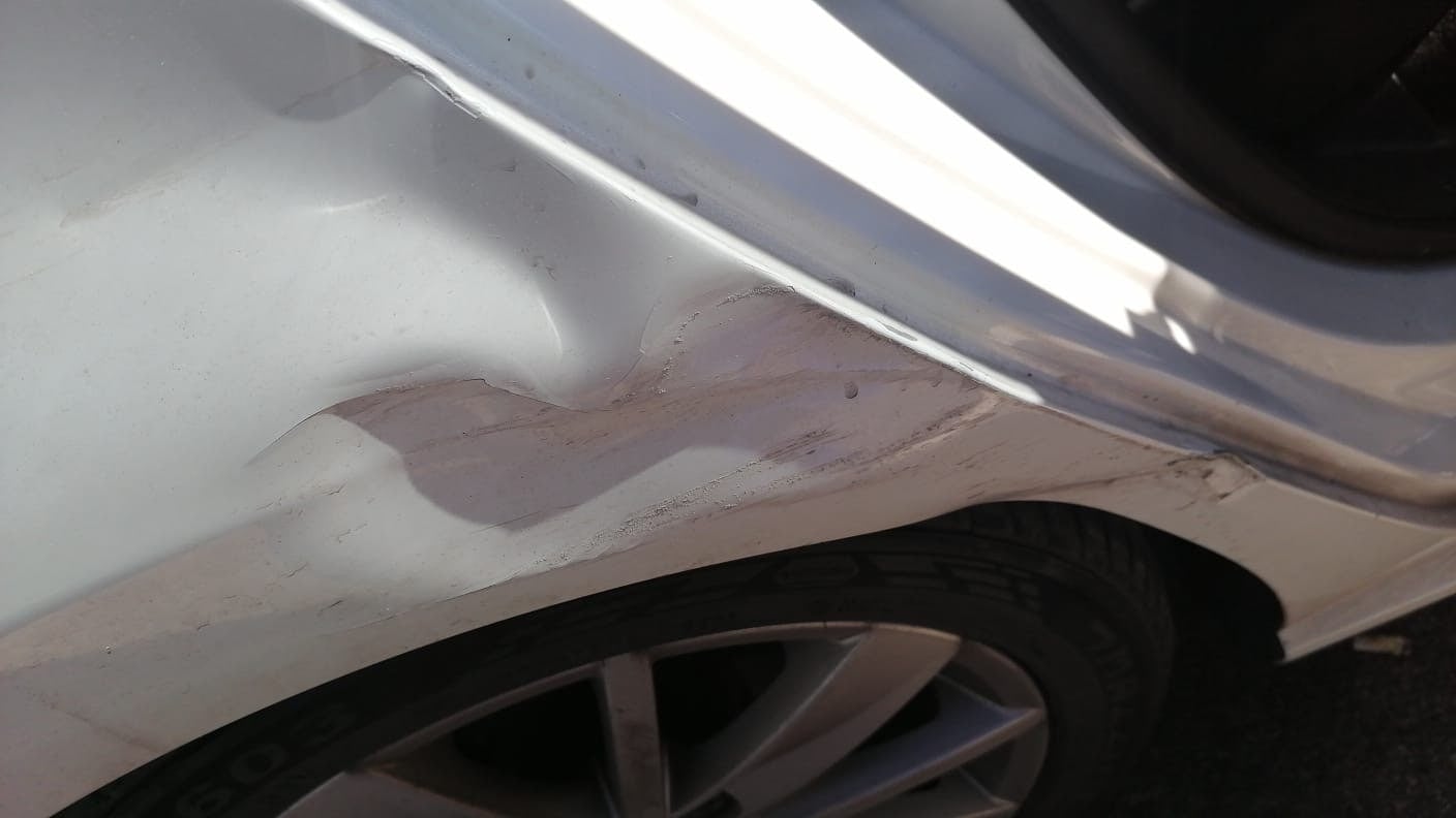 Close view of Volkswagen Polo dent and paint damage before repair